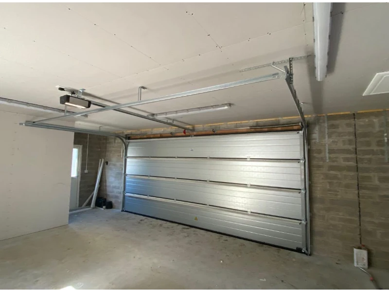 Interior view of sectional overhead door installation with track system commercial door & dock services in Alvin, TX.