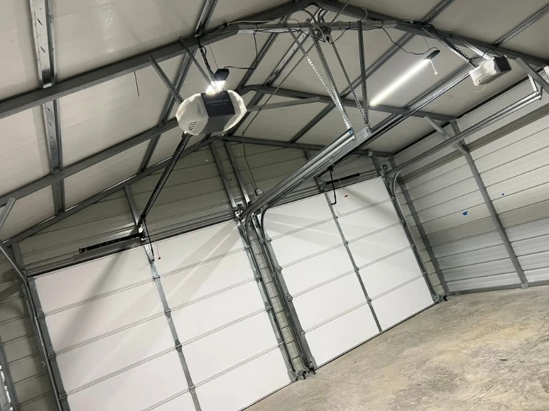 Warehouse interior with multiple commercial overhead doors and door operators installed.
