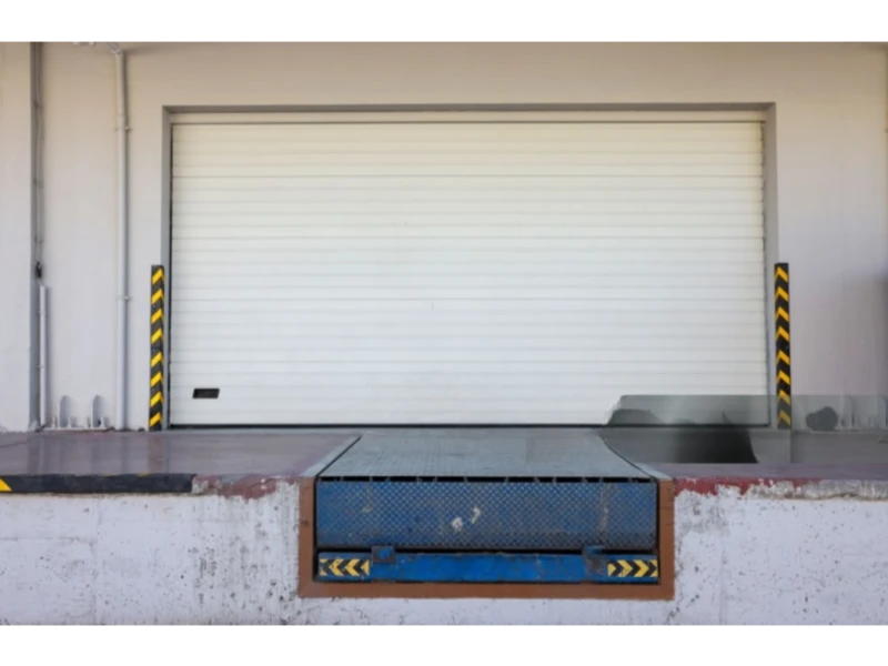 Loading dock with roll-up door and blue dock leveler platform – Dock Leveler & Dock Equipment Repair Alvin, TX