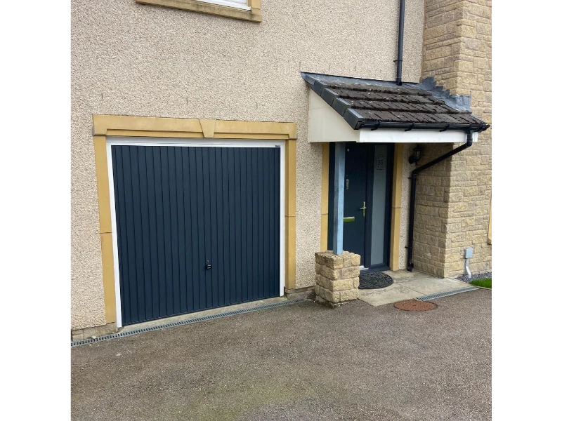 Emergency Garage Door Repair in Alvin, TX – dark gray vertical-panel garage door beside entryway