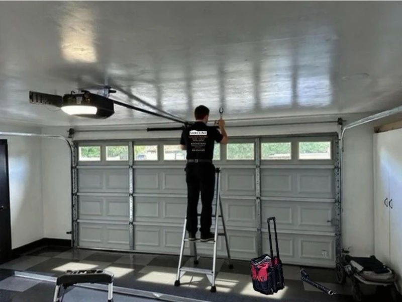 Fire Door Inspection & Drop Testing Alvin, TX – technician inspecting overhead door opener on ladder