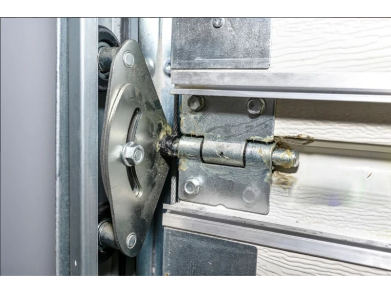 Garage Door Cable, Drum & Bottom Bracket Repair in Alvin, TX – Hinge, roller, and bracket assembly on a sectional garage door panel