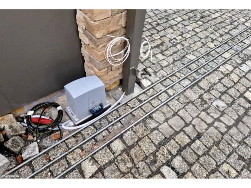 Garage Door Cable, Drum & Bottom Bracket Repair in Alvin, TX – Garage door opener motor rails and wiring setup near the ceiling
