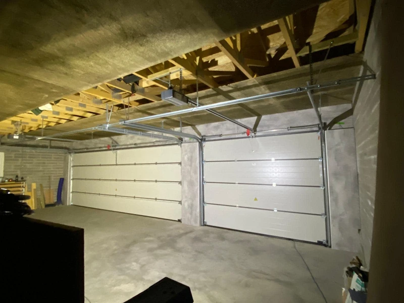 Garage Door Hardware Repair & Tune-up Services in Alvin, TX – double garage doors with track and hardware inspection.
