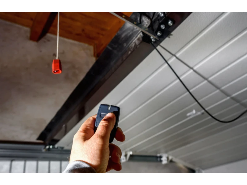 Garage Door Keypad & Remote Programming in Alvin, TX – remote test near the opener track and emergency release cord.