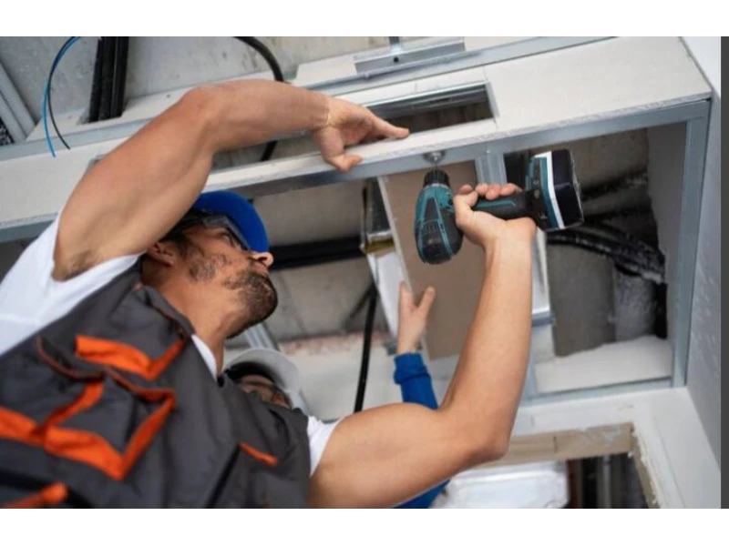 Garage Door Opener Installation in Alvin, TX - drilling mounting bracket for opener support
