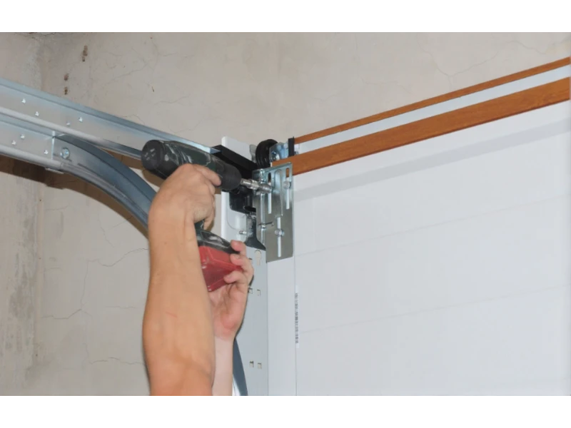 Garage Door Opener Installation in Alvin, TX - drilling and securing track bracket hardware
