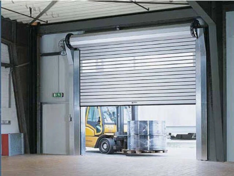 Industrial rolling steel door repair with track and roller service in Alvin, TX.