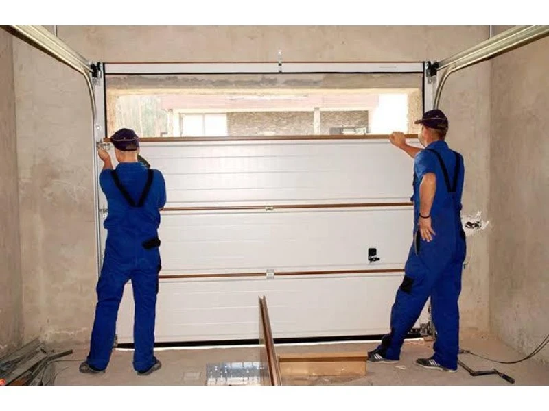 Off-Track Garage Door Repair in Alvin, TX – garage door panels being aligned during installation.