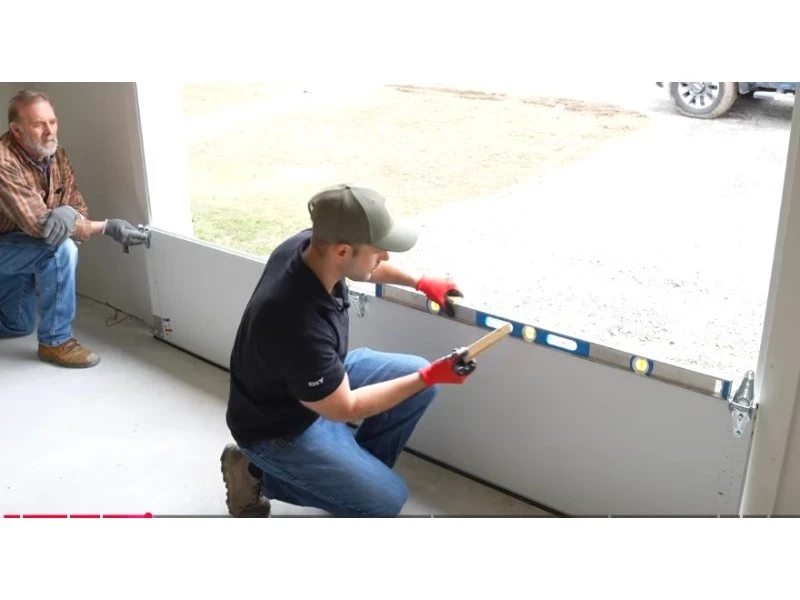 Off-Track Garage Door Repair in Alvin, TX – garage door panels being aligned during installation.
