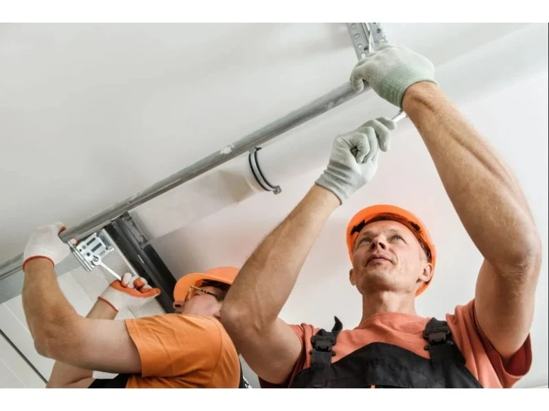 Off-Track Garage Door Repair in Alvin, TX – commercial overhead garage door service inside a shop.