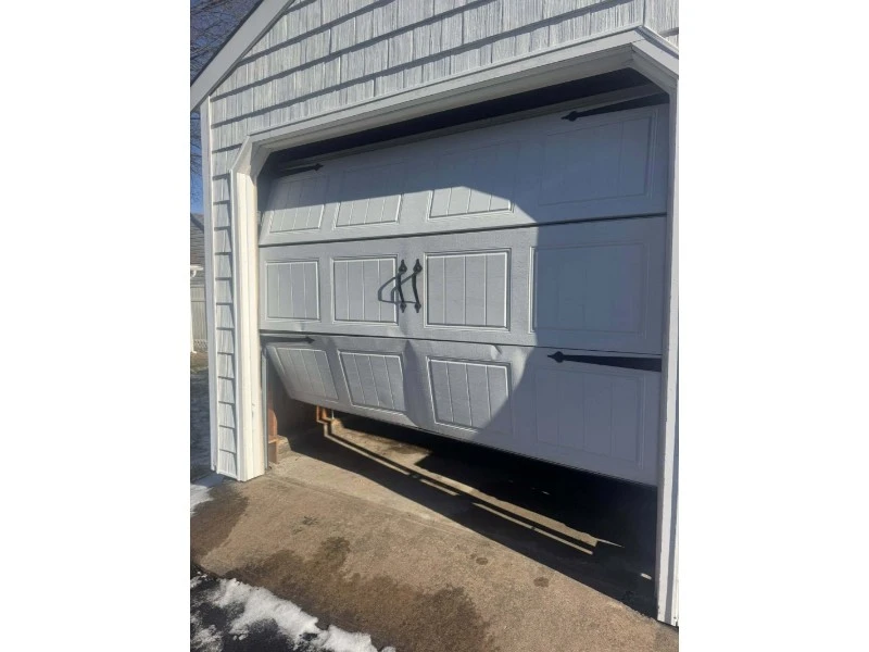 Best & Reliable Garage Door repair services in Alvin, TX – Off-track garage door with a bent panel needing repair.
