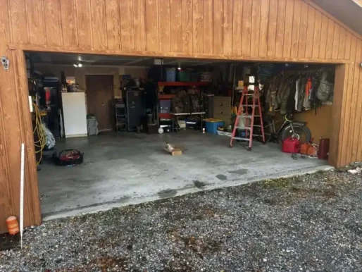 Open garage with storage—door alignment and repair services offered in Alvin, TX.