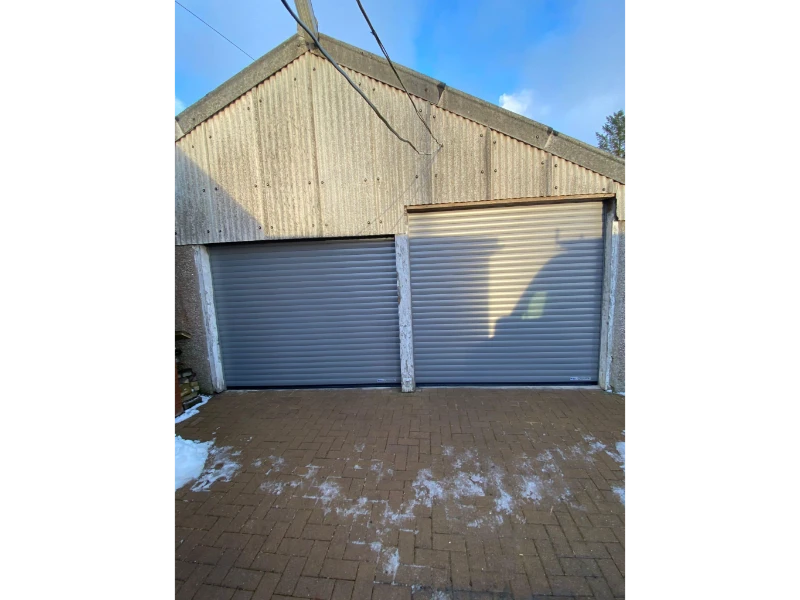 Two-bay rolling garage doors installed for a clean, durable finish (Alvin, TX).