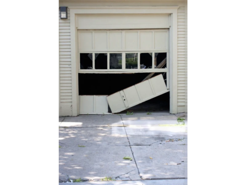 Off-Track Garage Door Repair in Alvin, TX – damaged garage door panel knocked off the track.

