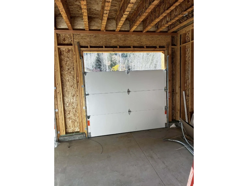 Off-Track Garage Door Repair in Alvin, TX – garage door panels being aligned during installation.
