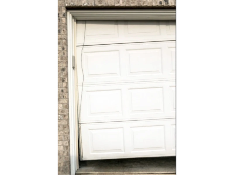 Off-Track Garage Door Repair in Alvin, TX – crooked garage door hanging off the track on one side.
