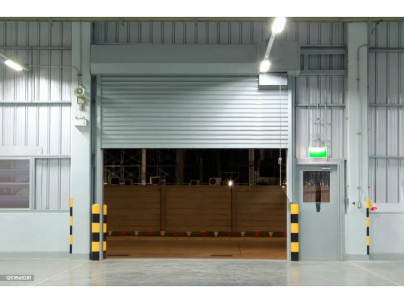Commercial rolling steel door repair Alvin, TX – door half open at facility